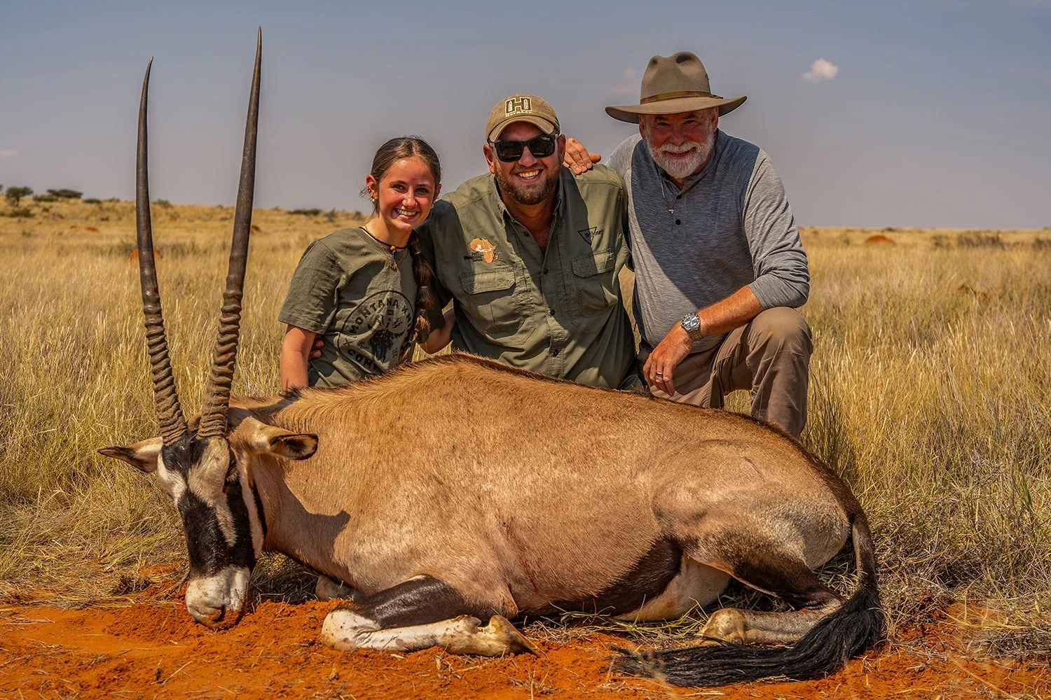 three hunters with gemsbok