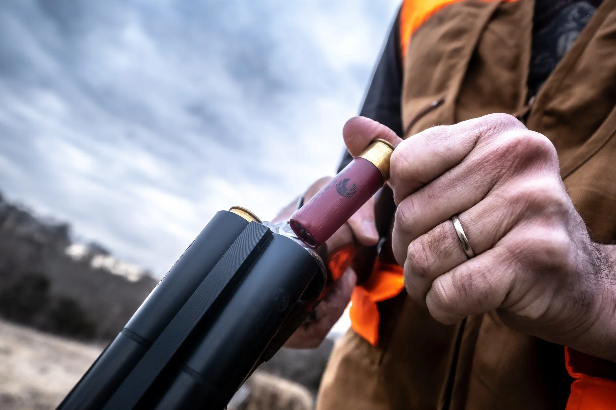 Man loading a shotgun.