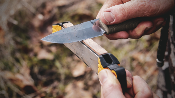 Man sharpening pocket knife on Work Sharp Guided Field Sharpener