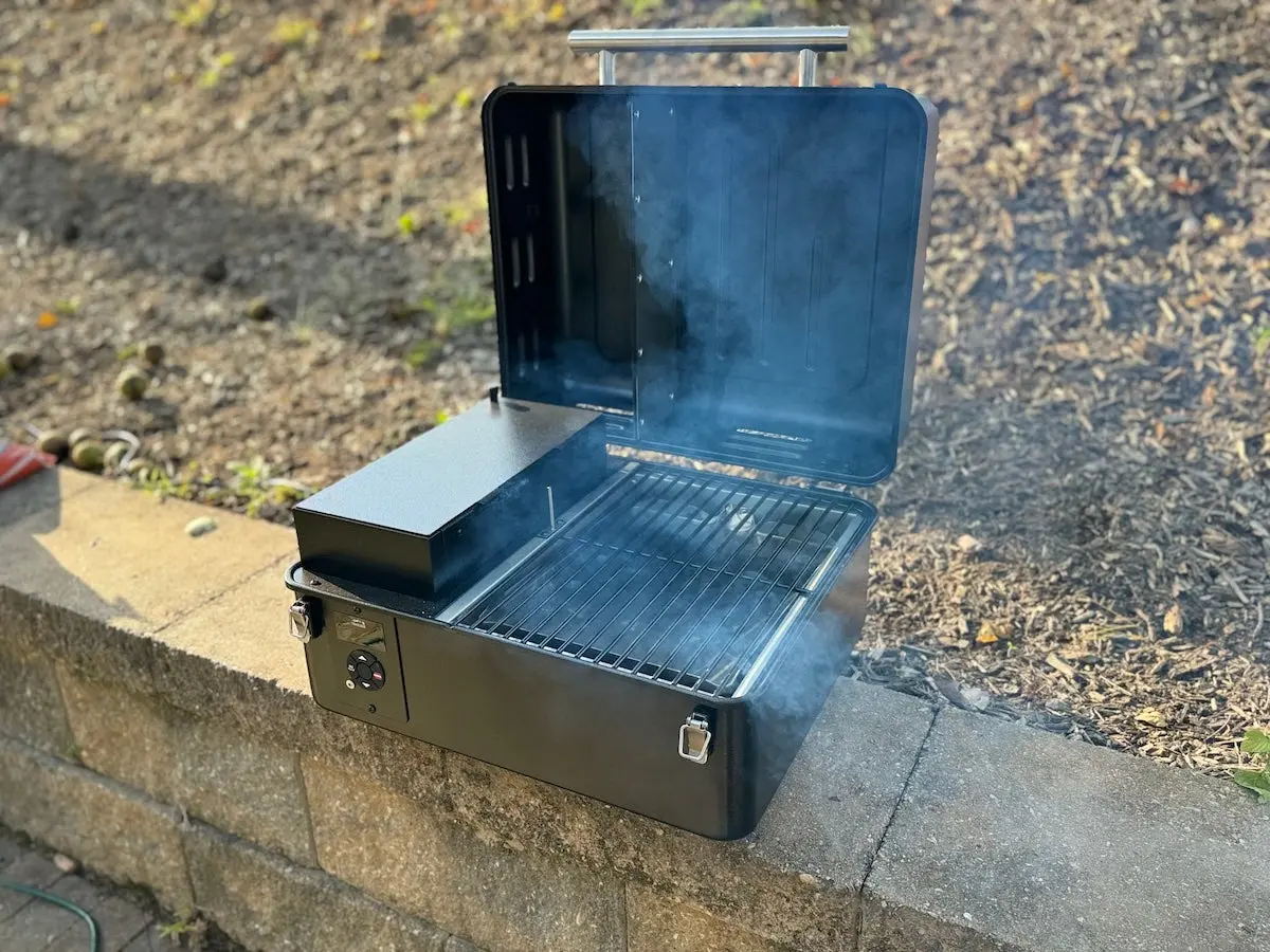 Traeger Ranger Portable Pellet Grill and Smoker open and smoking on ledge