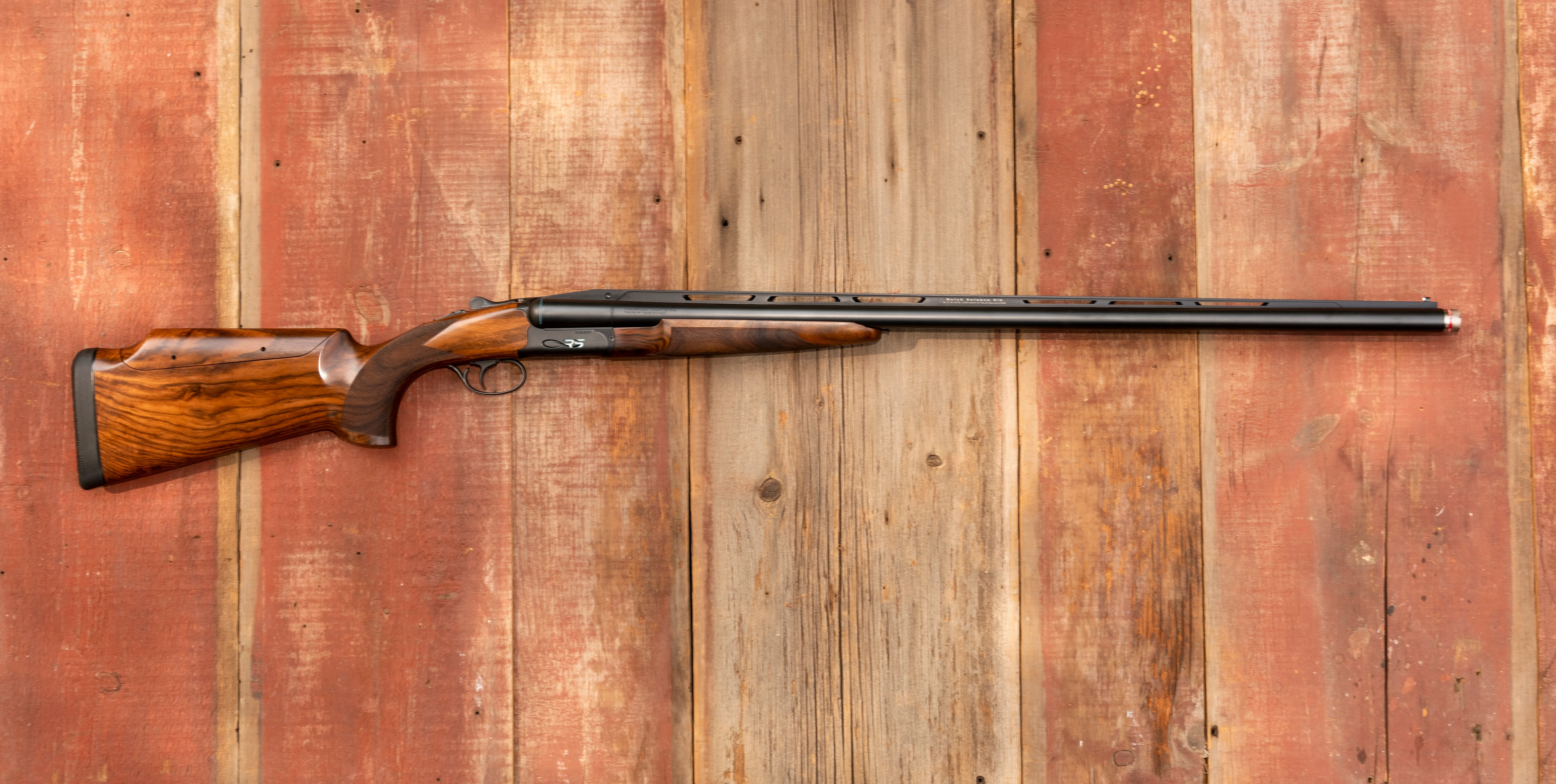 Fabarm Infinite RS shotgun on a barn-board background.