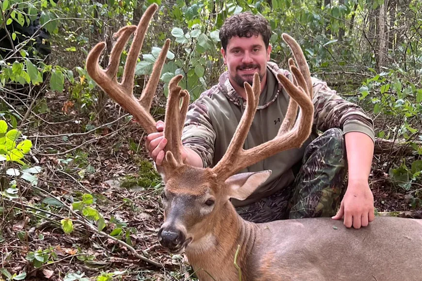 A Kentucky hunter poses with a 199-inch whitetail taken in full velvet.
