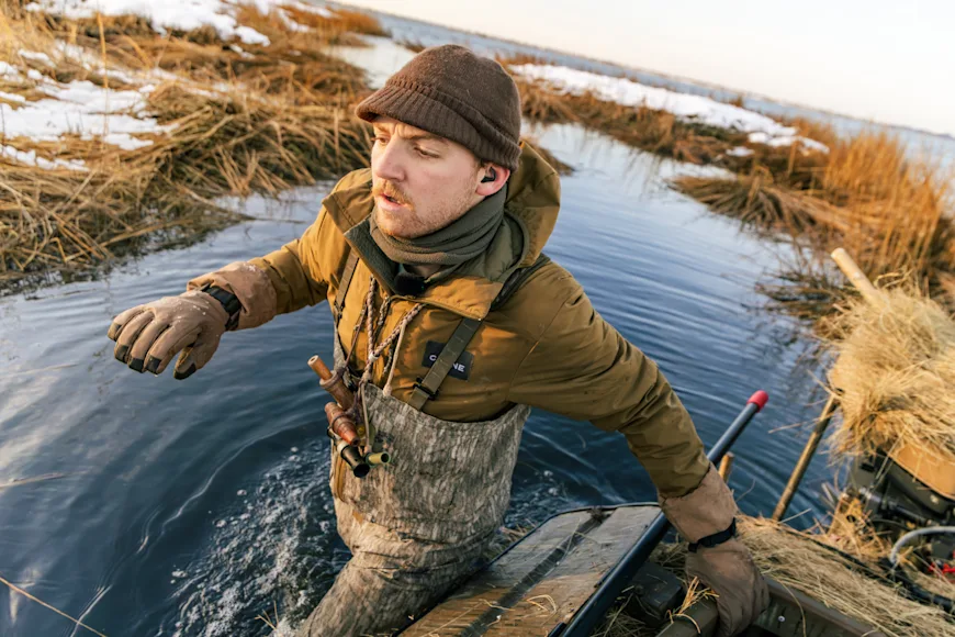 Hunter walking in water
