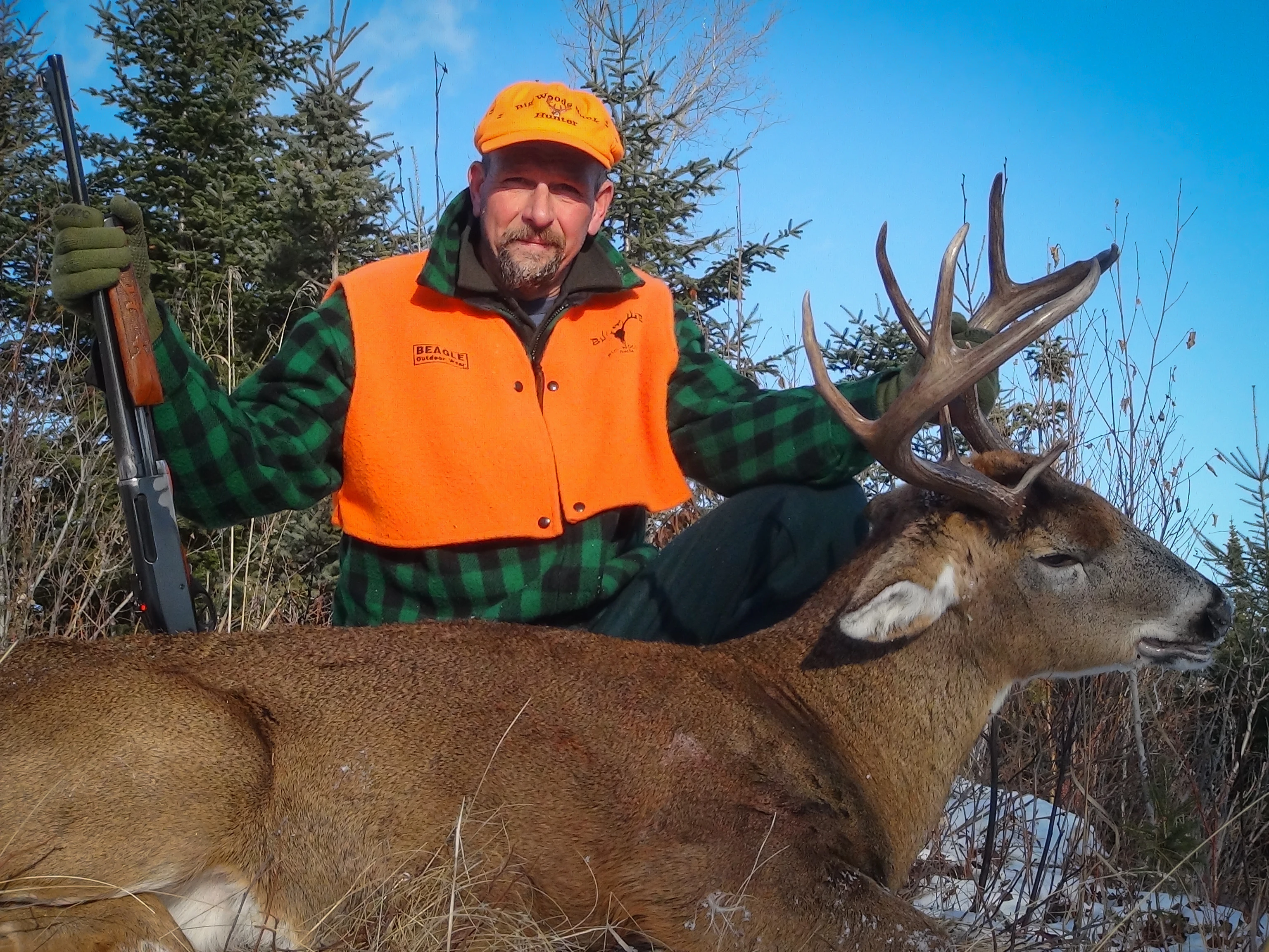 Legendary Maine tracker Hal Blood poses with a nice whitetail buck. 