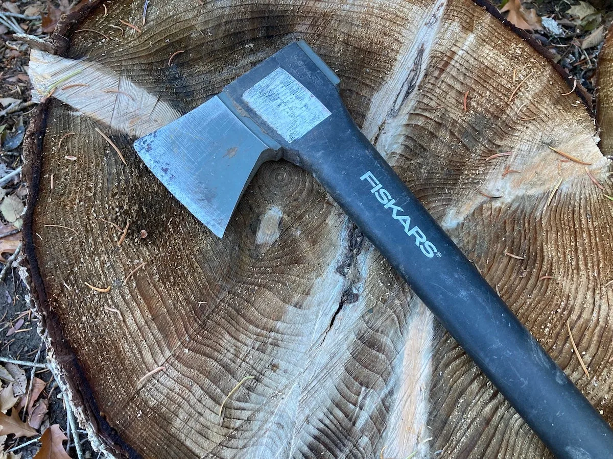 Fiskars X27 Super Splitting Axe head lying on log