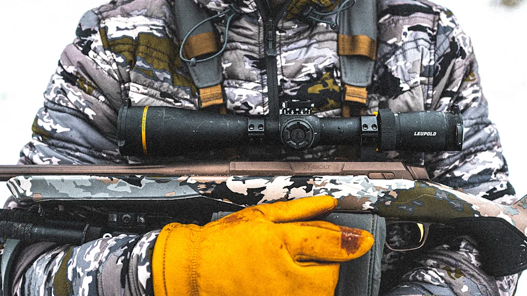 Hunter holding rifle across their chest