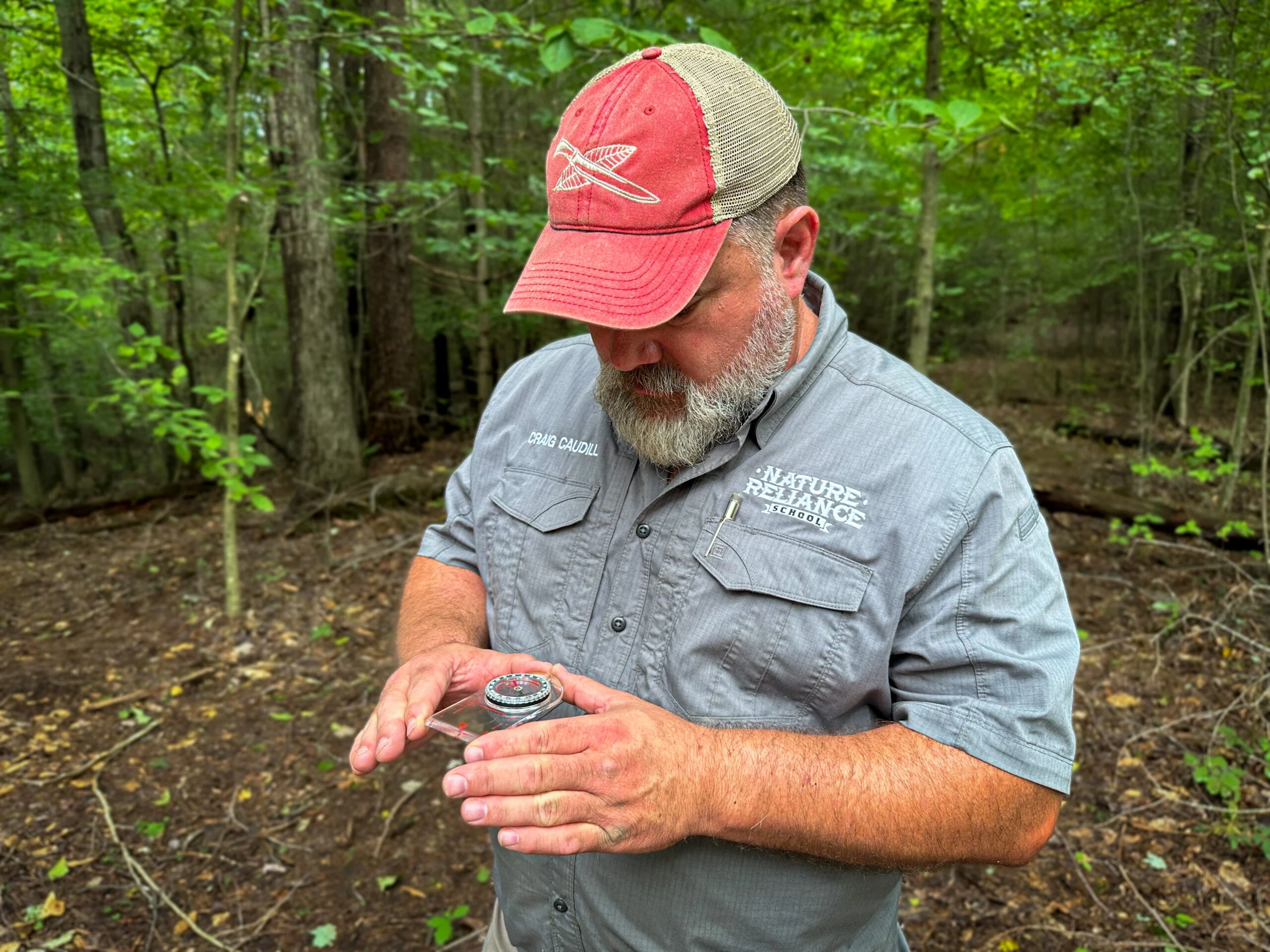 outdoorsman holding a compass