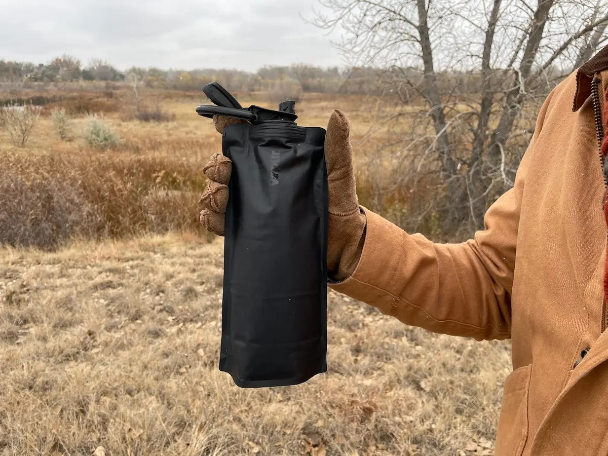 Hiker holding Vapur Wide Mouth Anti-Bottle