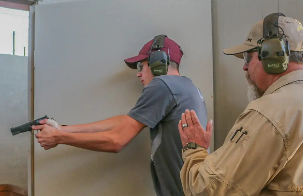 Two men in a handgun shooting drill