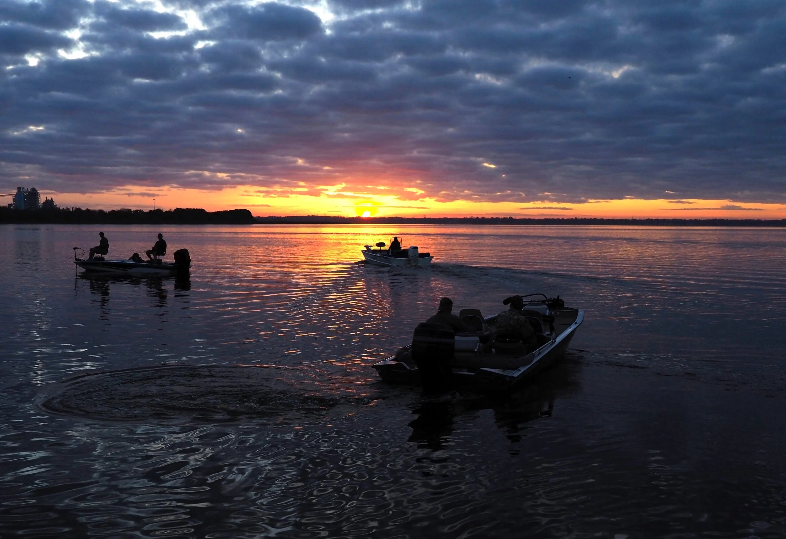 Unrecognizable Silhouette of Fisherman Heading Out to Their Favorite Fishing Sites at Sunrise on a Florida Lake