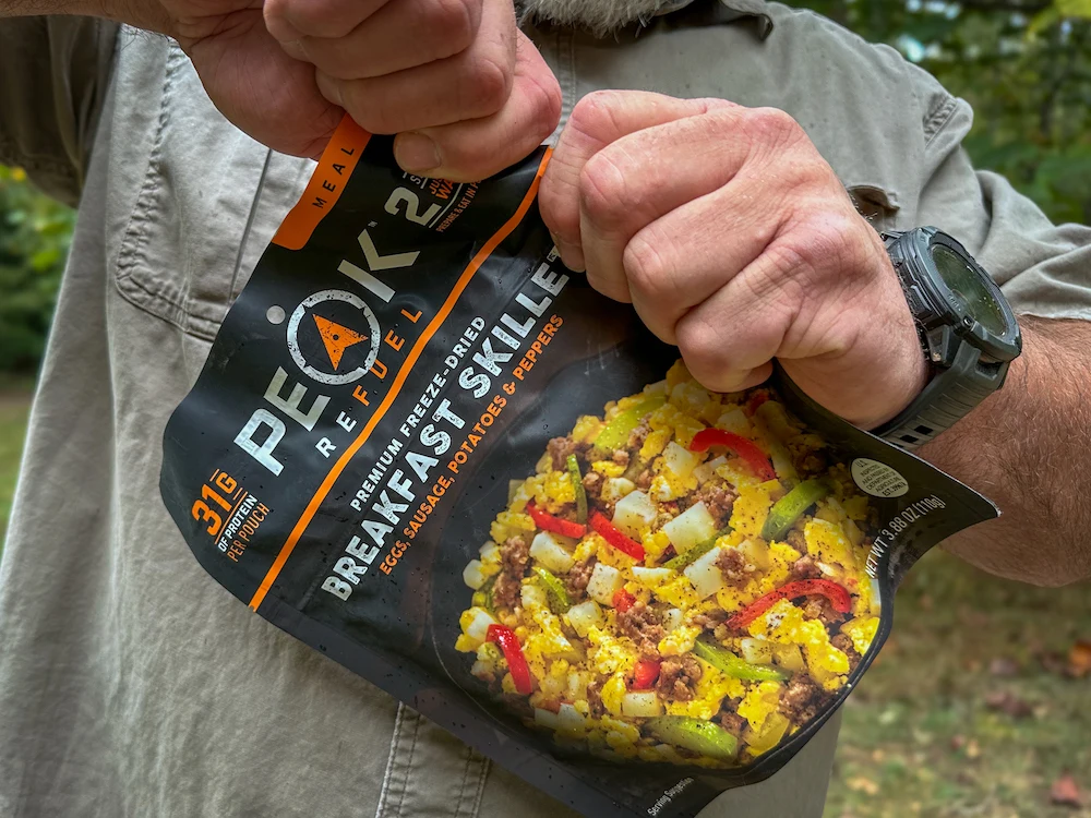 Man opening Peak Refuel Freeze-Dried Meal