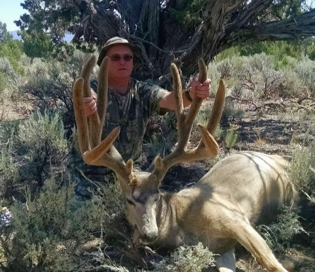 A hunter poses with a world record mule deer in Nevada. 