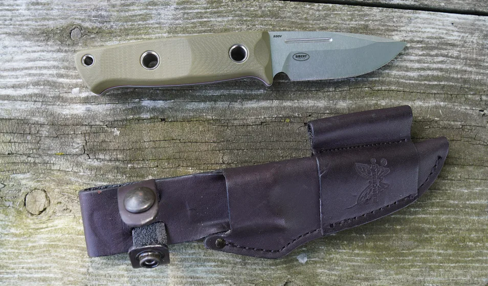 Close-up of Benchmade Mini Bushcrafter and sheath on wood table