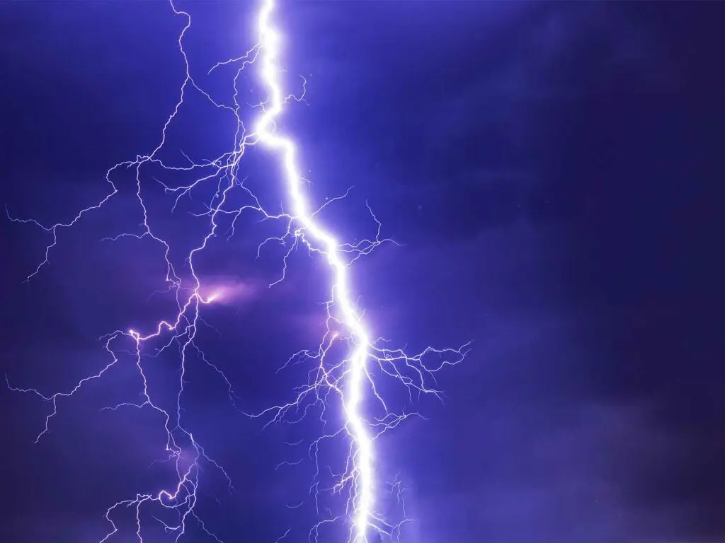 a lightning strike across a purple sky