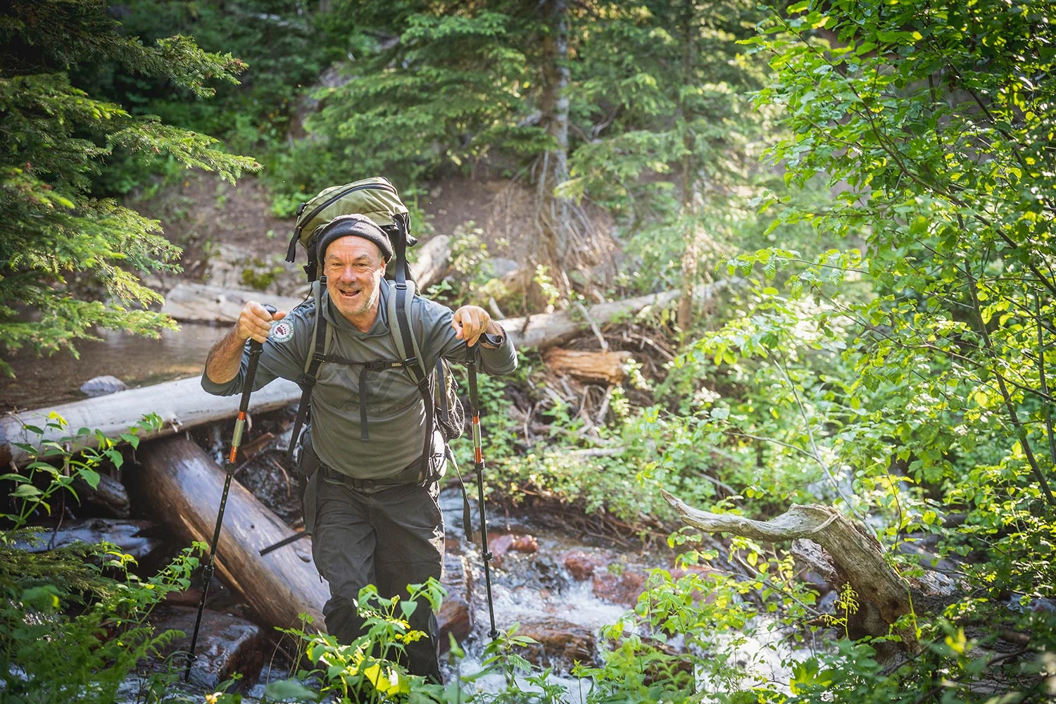 Hal Herring hiking across stream