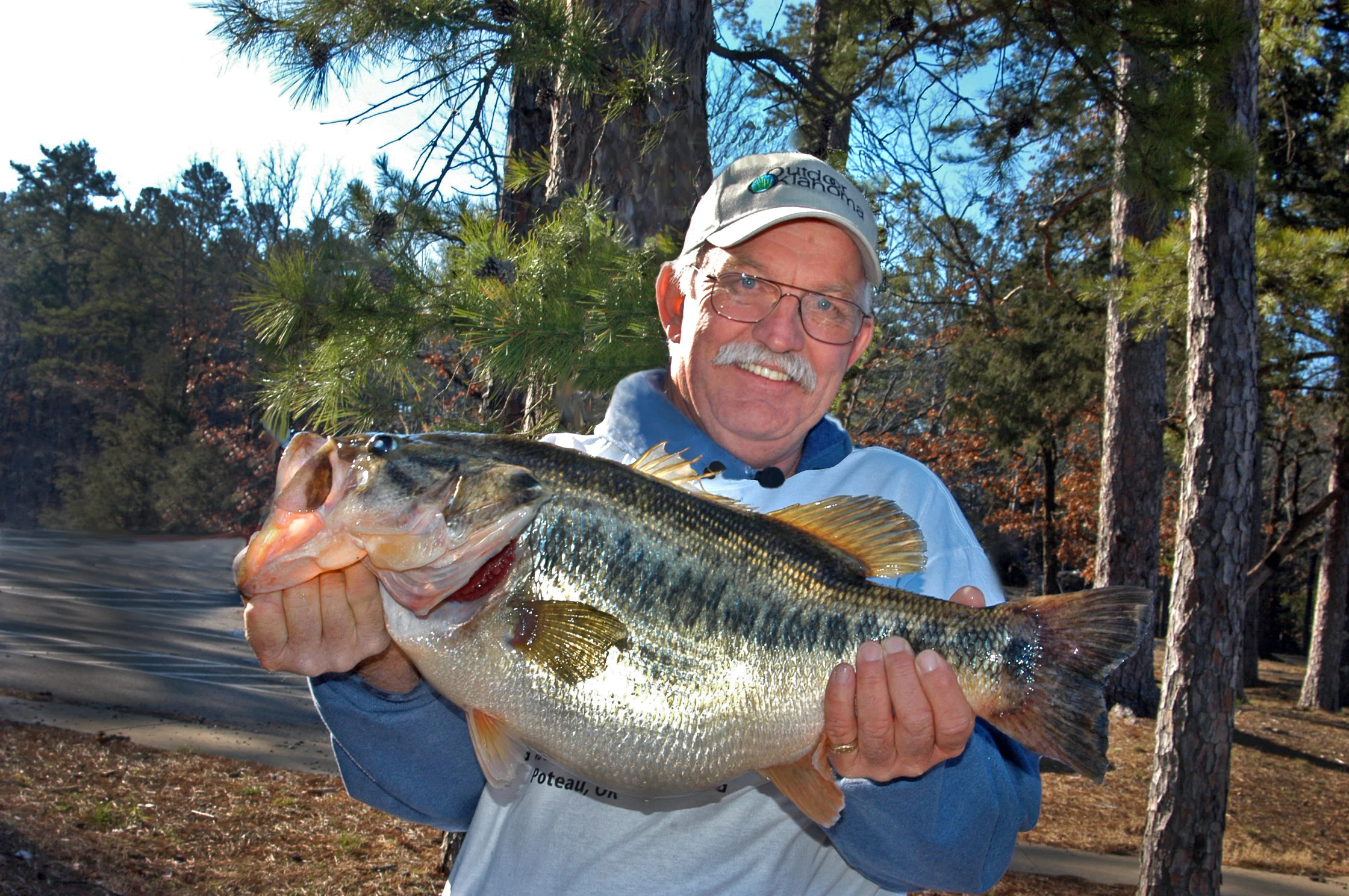 An angler poses with the Oklahoma state record largemouth bass. 