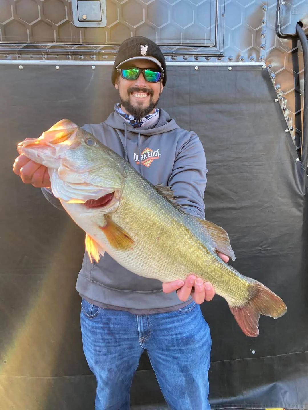 A professional angler poses with a largemouth bass caught in Florida. 