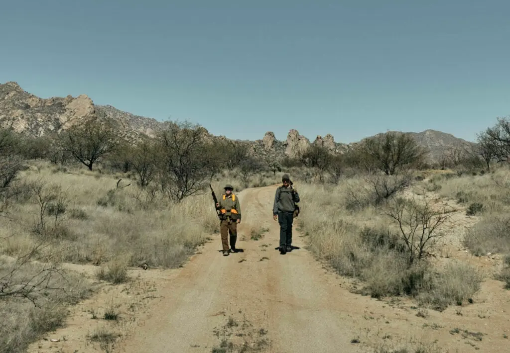 hunters walking a dirt road in Arizona.