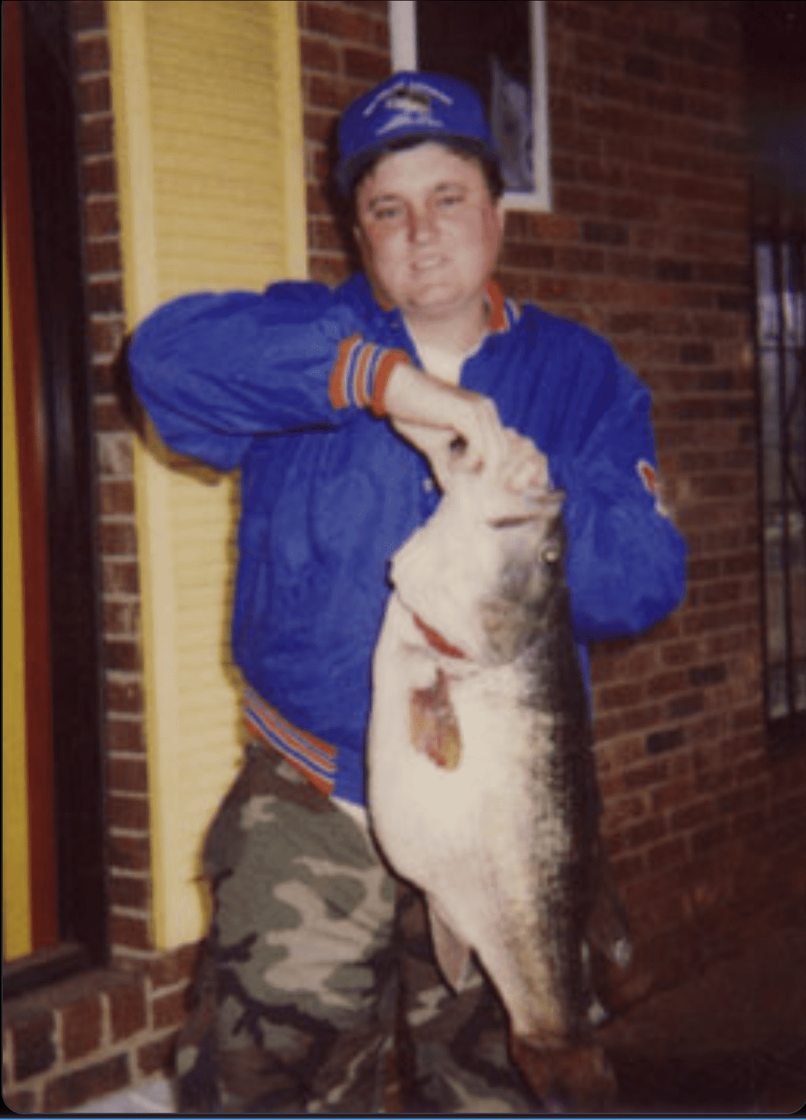 An angler poses with a North Carolina state record for largemouth bass. 