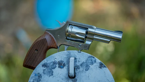 The new Colt Viper revolver resting on a steel plate at a gun range.