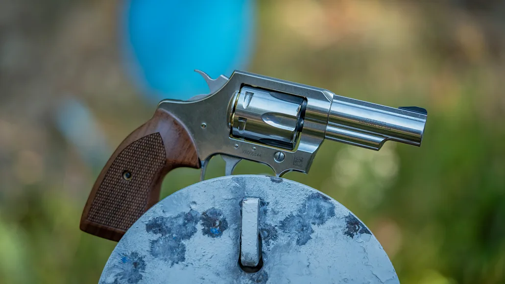 The new Colt Viper revolver resting on a steel plate at a gun range.