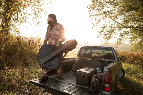 Hunter holding plano crossbow case