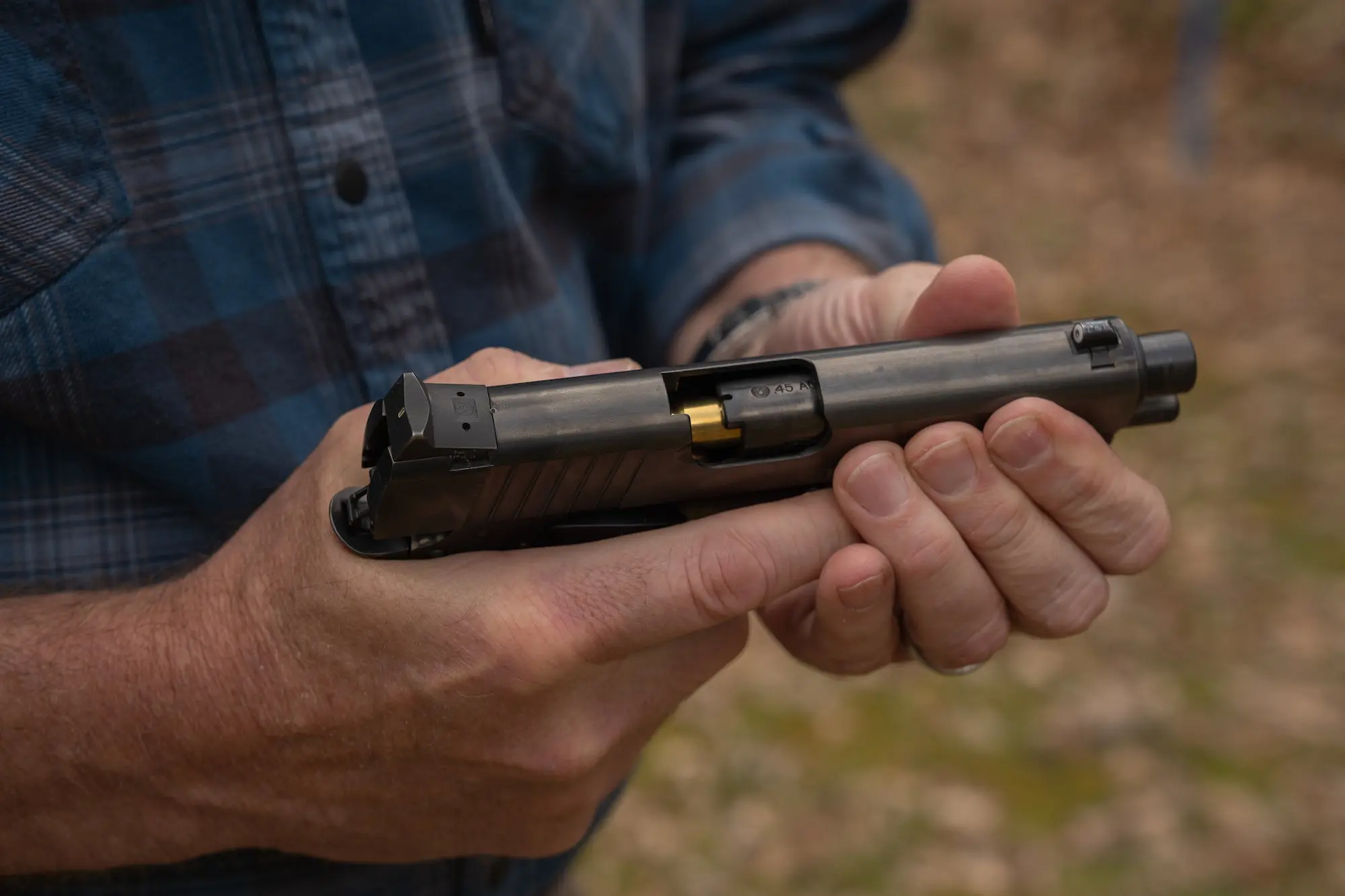 man unloading a pistol