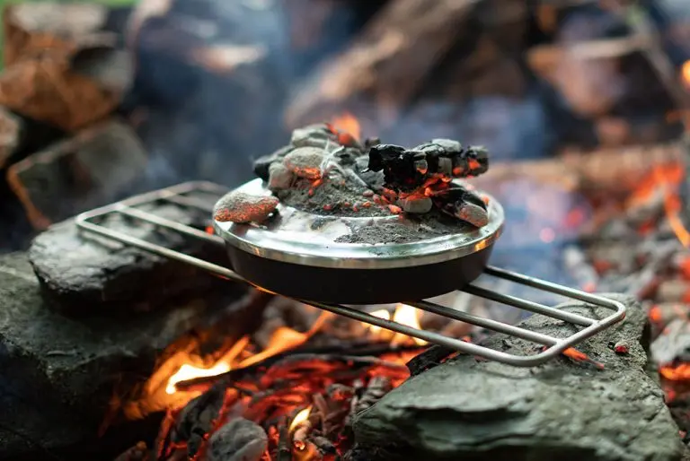 Closed pan over fire with coals on top of lid