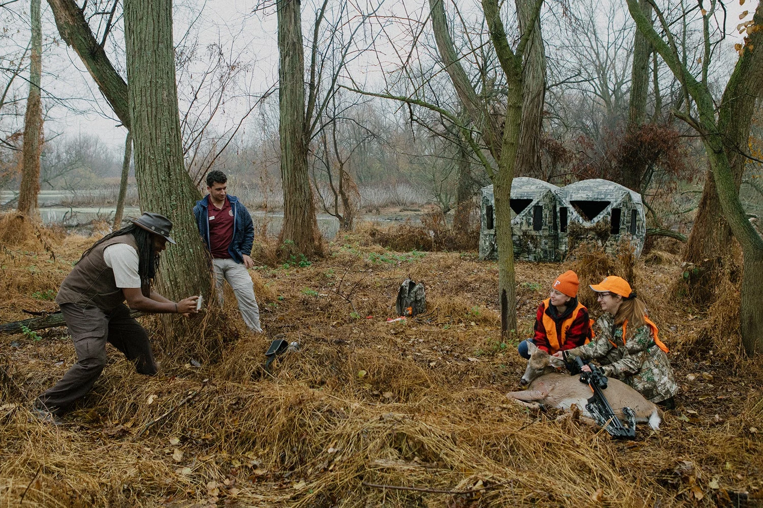 hunters pose for photo with deer