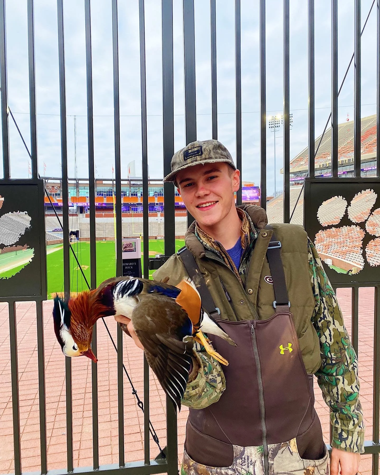 hunter holds mandarin duck in front of Clemson University