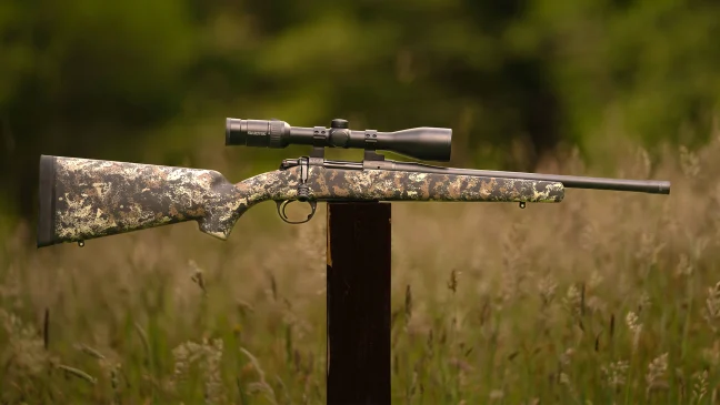 The new Wilson Combat Model 20S bolt-action rifle balance on a post in a field. 