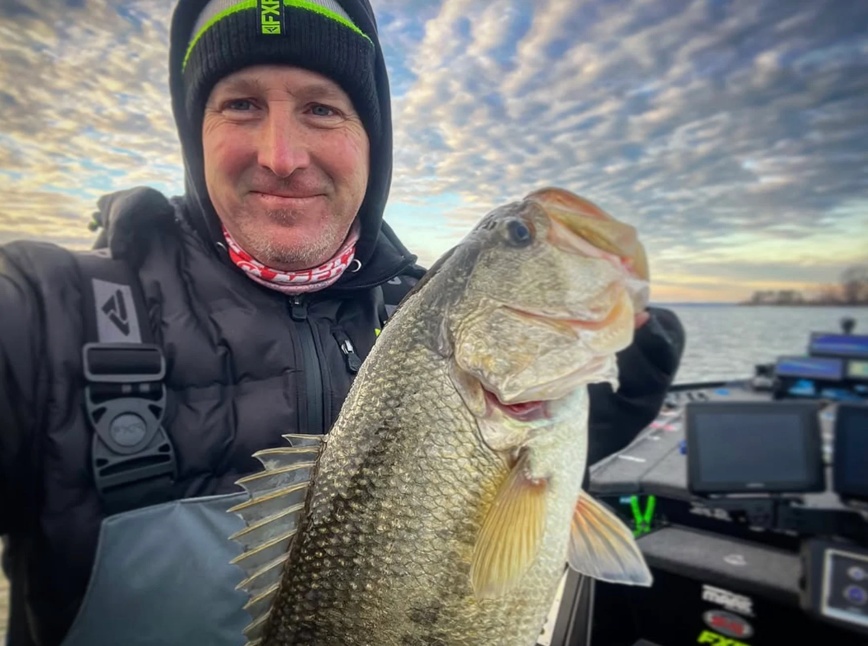 Angler holding up largemouth bass