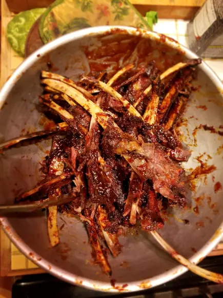 Bowl of deer ribs with barbecue sauce.