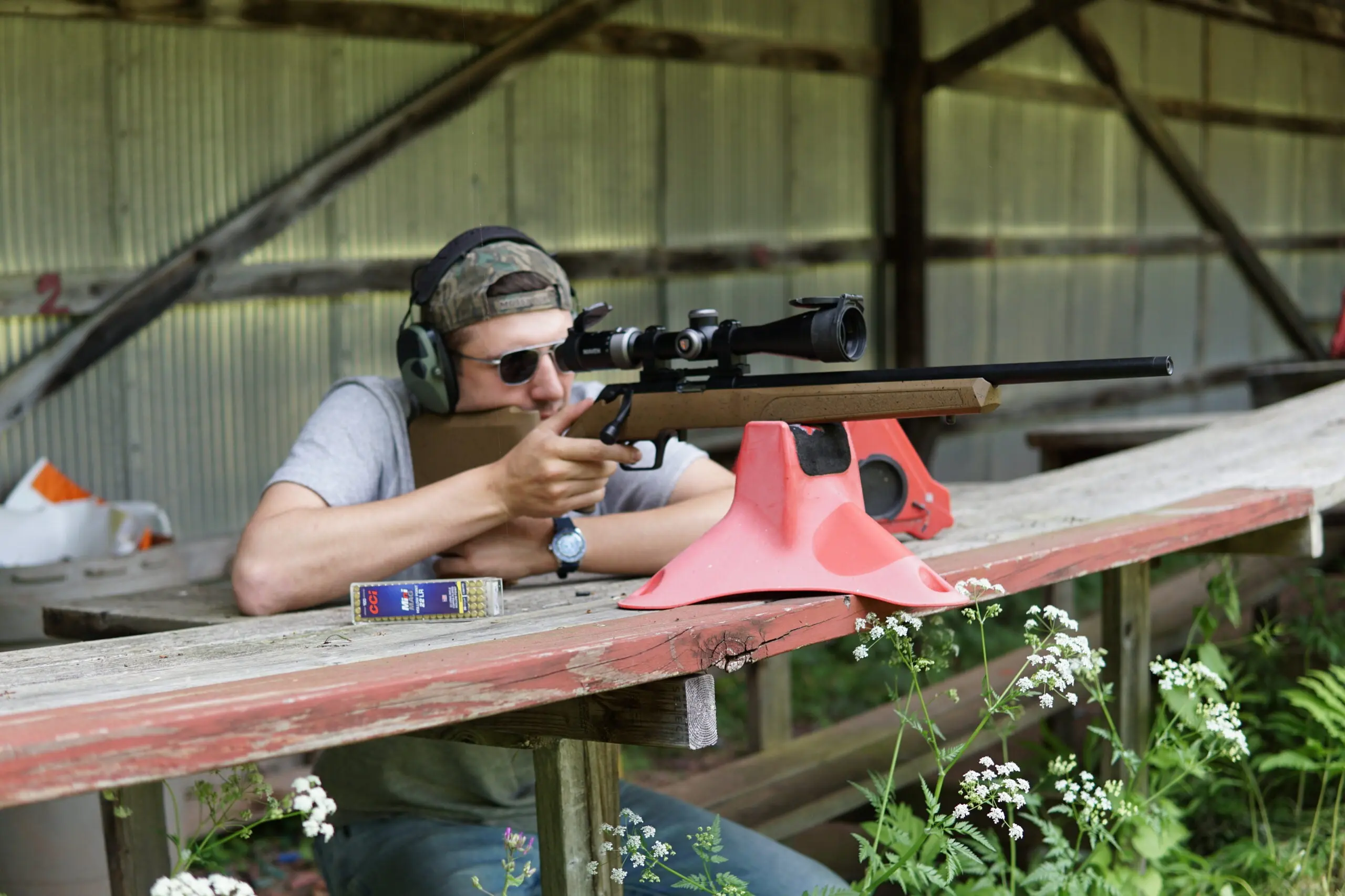 A shooter test firing the Springfield Armory Model 2020 Rimfire rifle from a bench. 