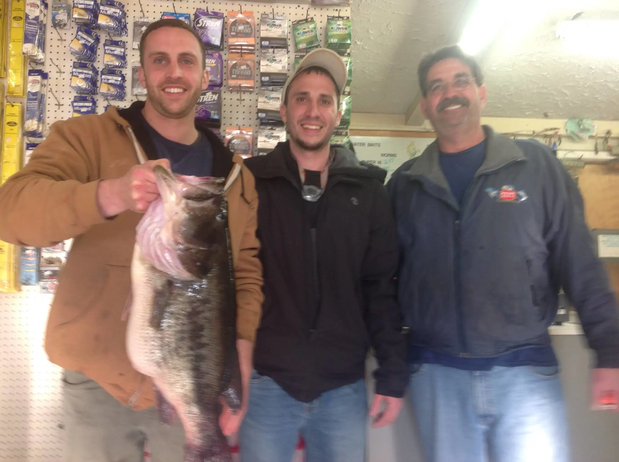 An angler poses with the Rhode Island state record for largemouth bass. 