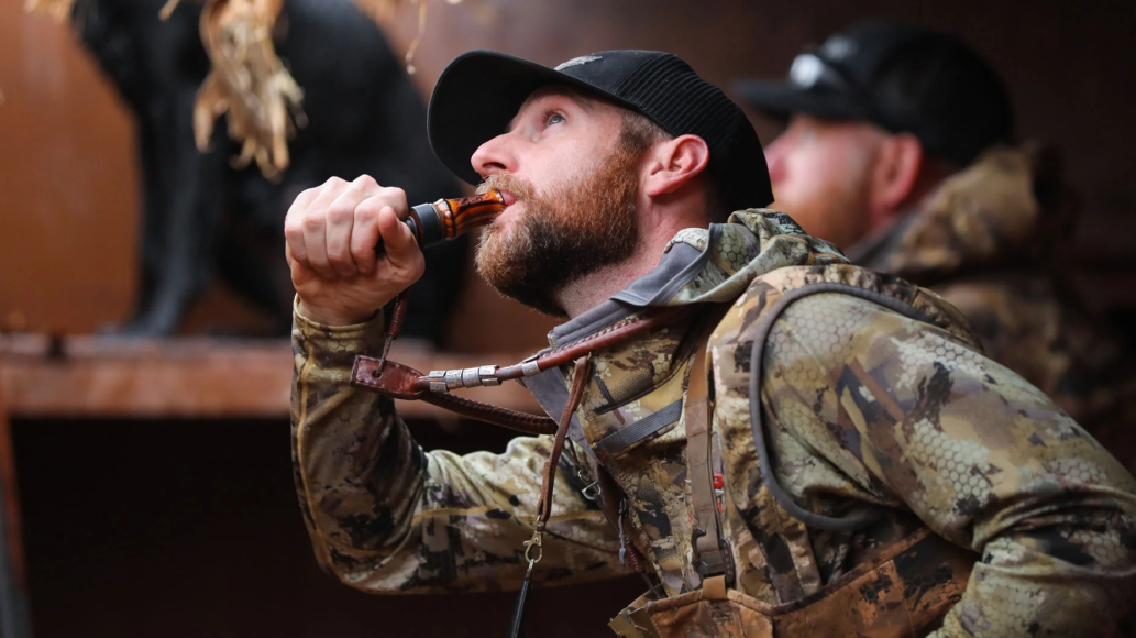 Waterfowl hunter using 737 Duck Call in blind