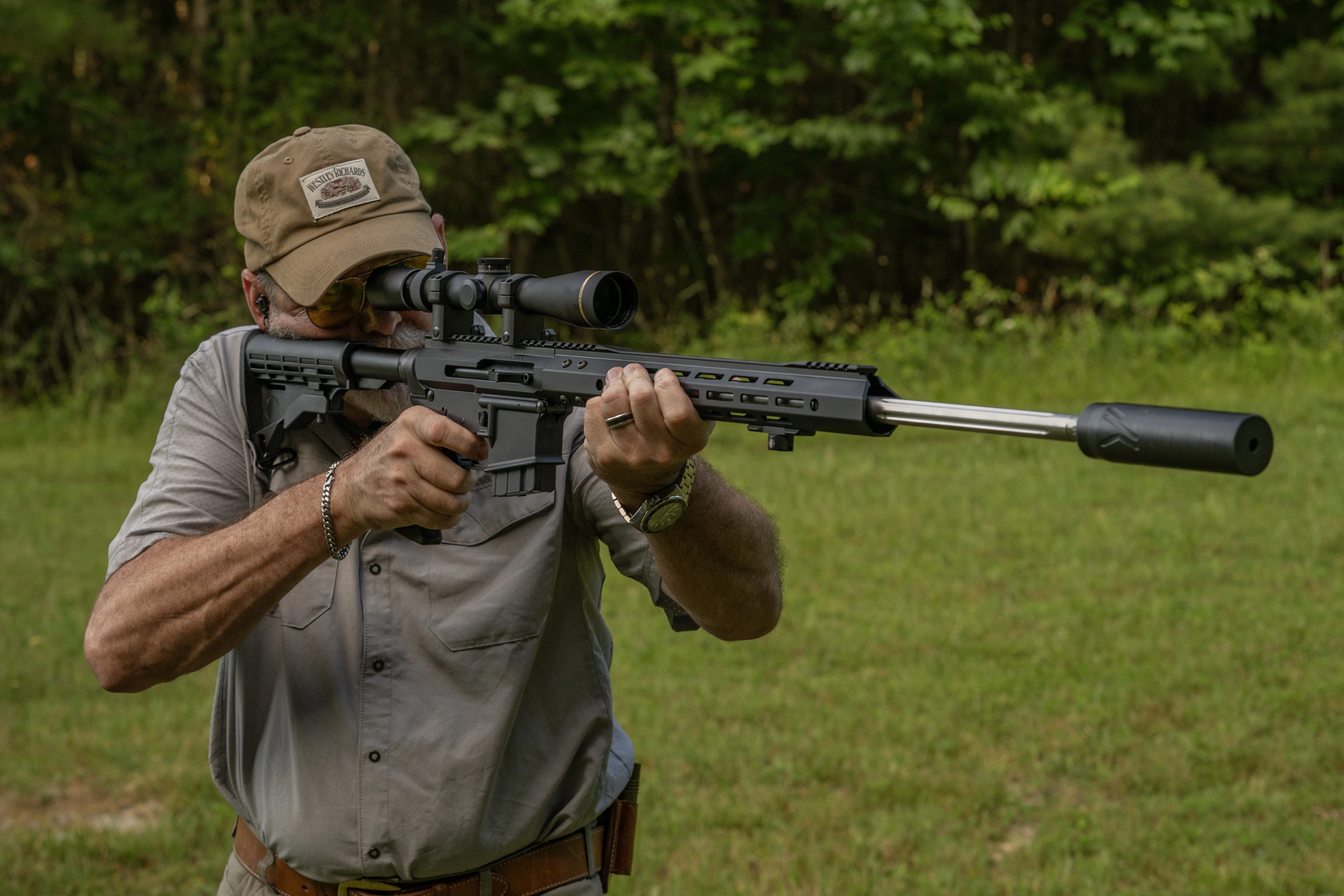 A shooter test fires the new Bear Creek Arsenal BC15 rifle in a field. 