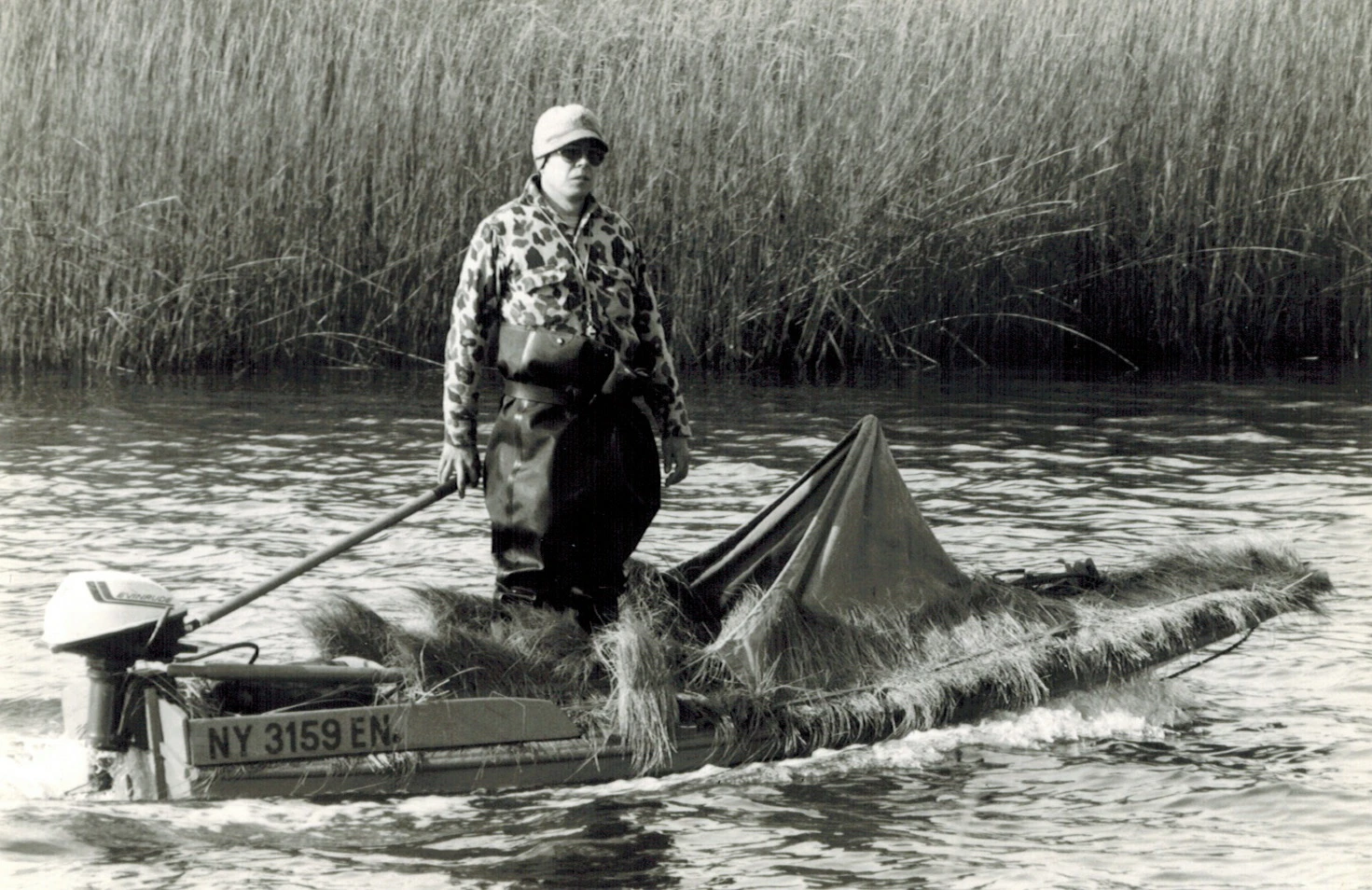 Duck hunter standing in duck boating 