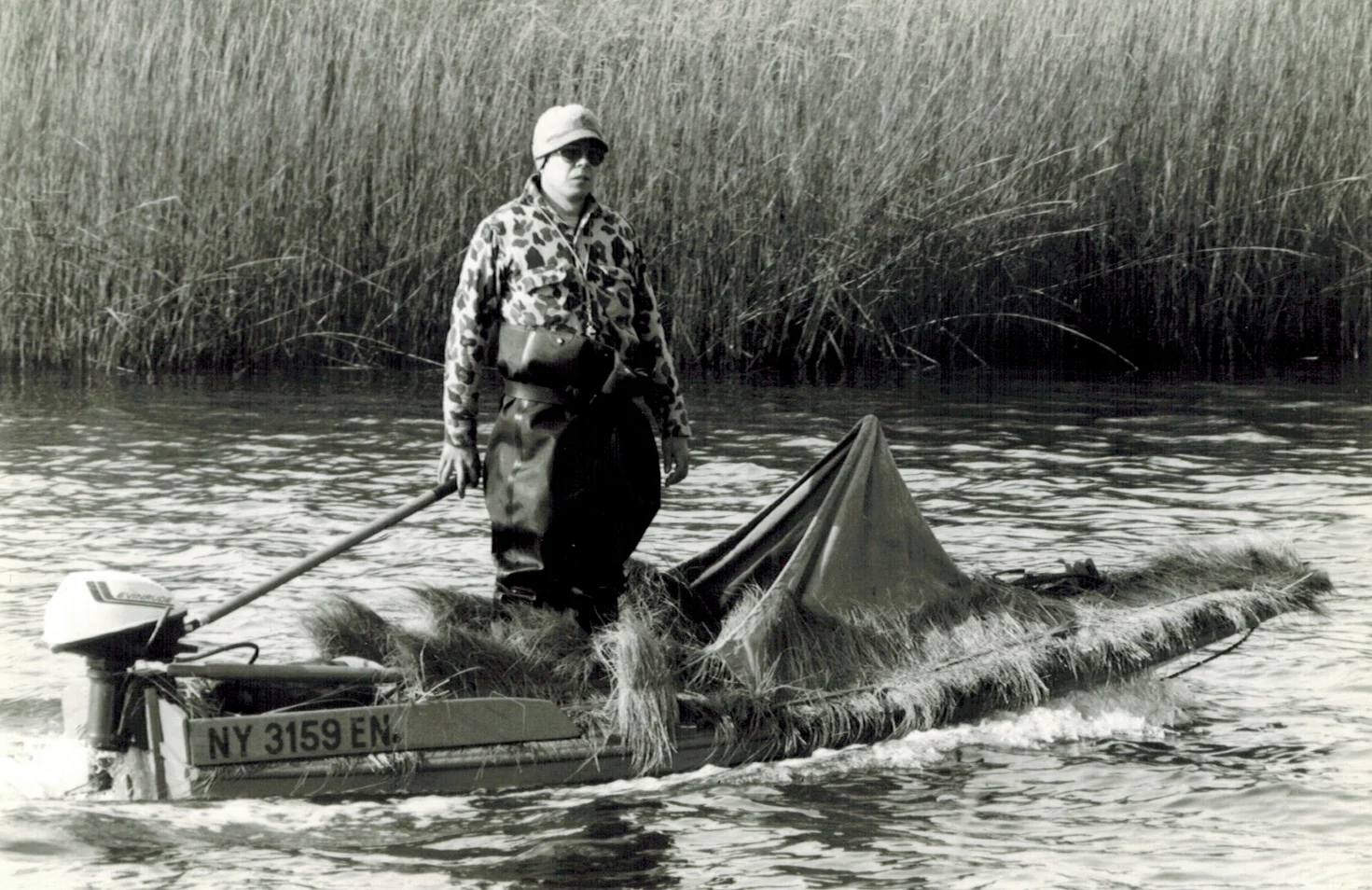 Duck hunter standing in duck boating 