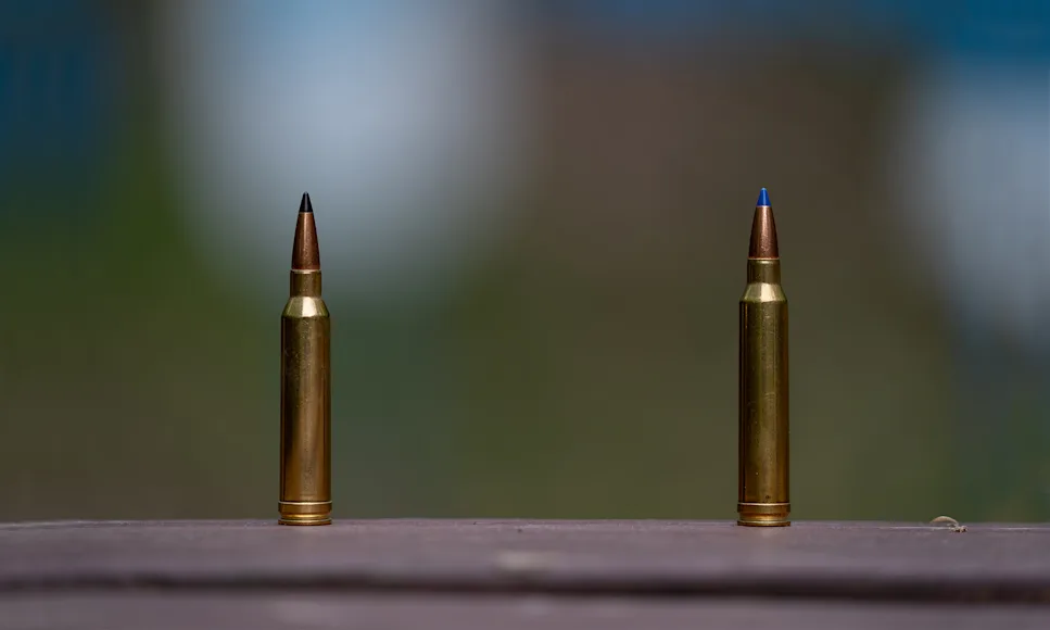 7mm Rem Mag vs 300 Win Mag loads resting on a board.