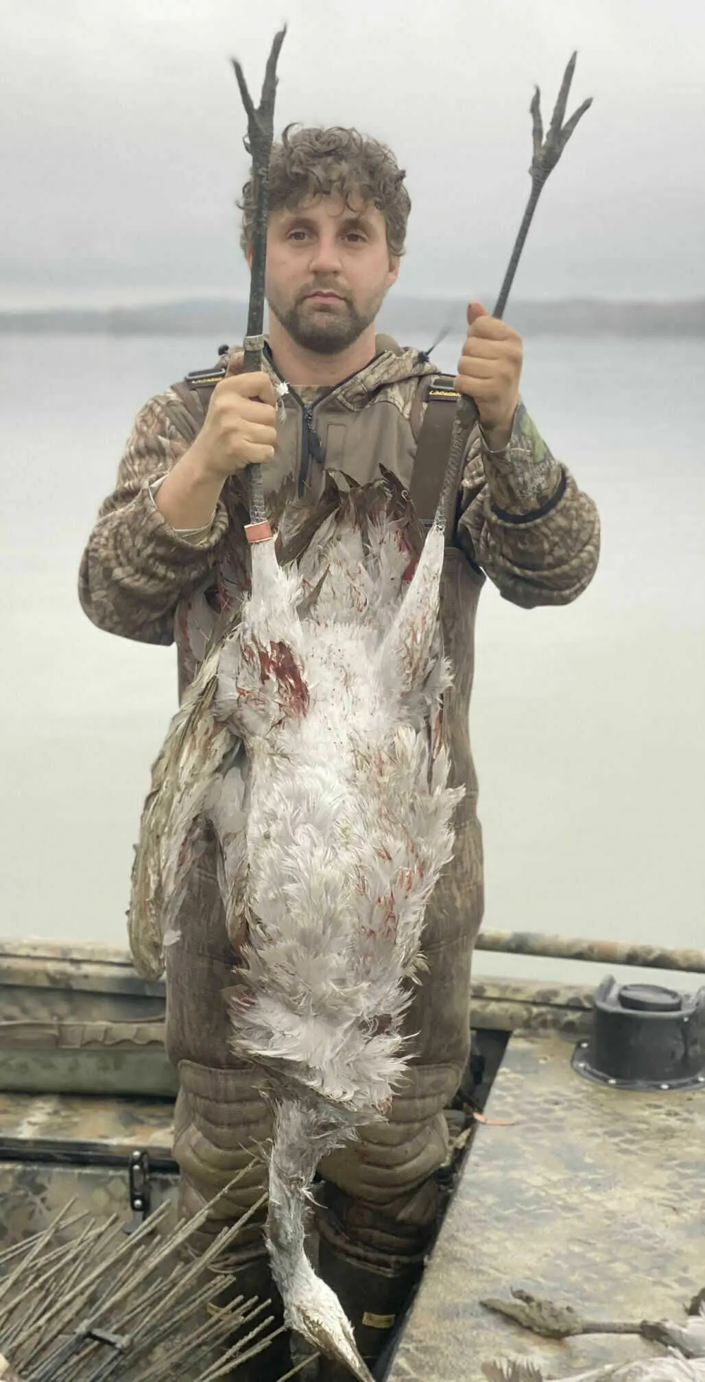 Hunter holding up banded sandhill crane