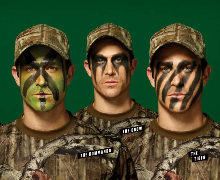 Three models pose with camouflage face paint.