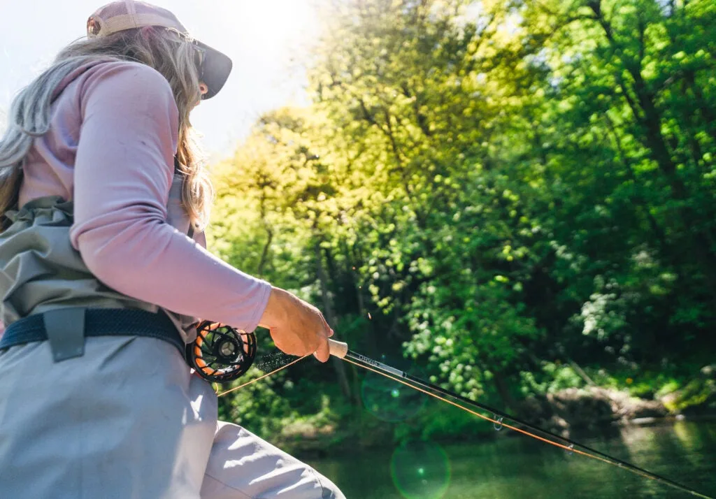 Fly angler fishes with the new Orvis Helios Blackout rod