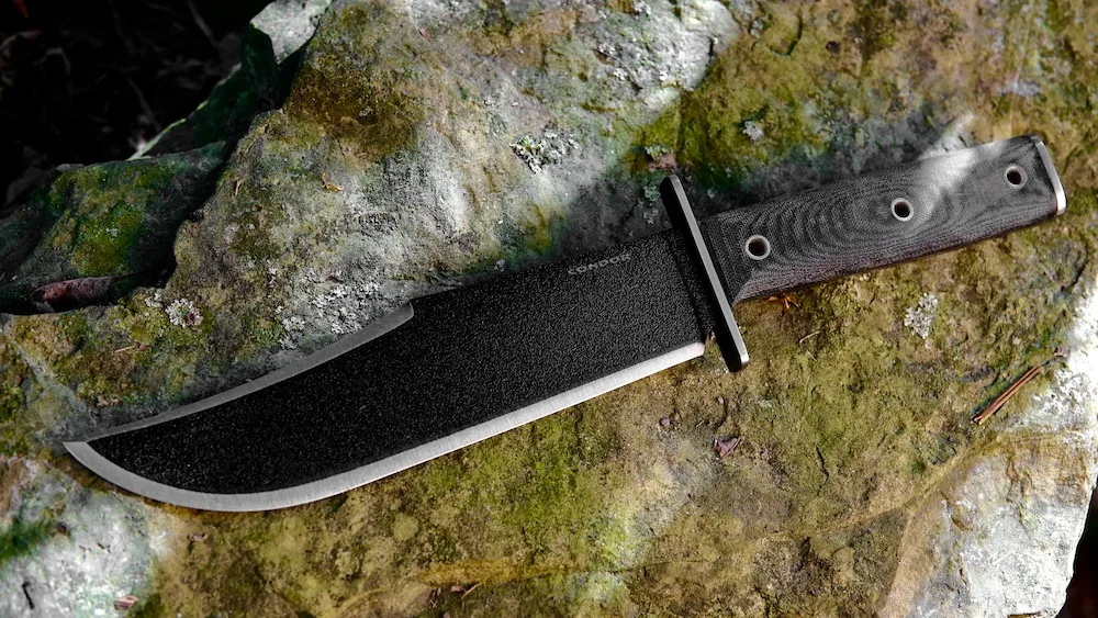 Condor Operator Bowie Knife lying on rock