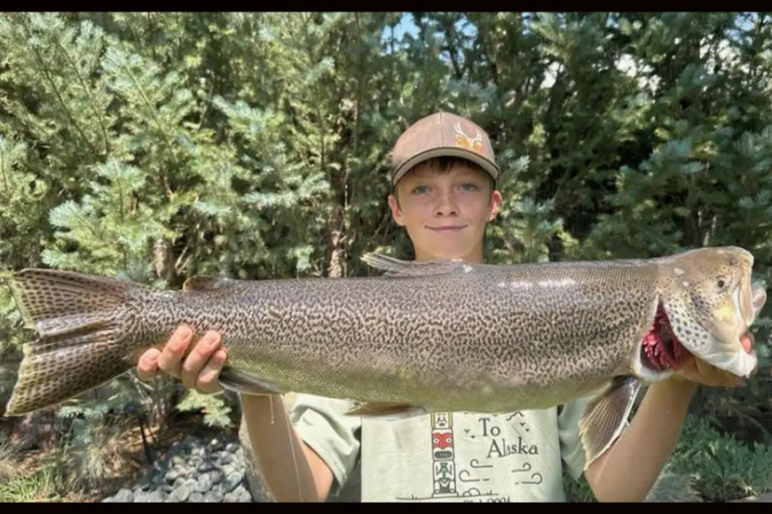 A Wyoming teen poses with a state-record tiger trout. 