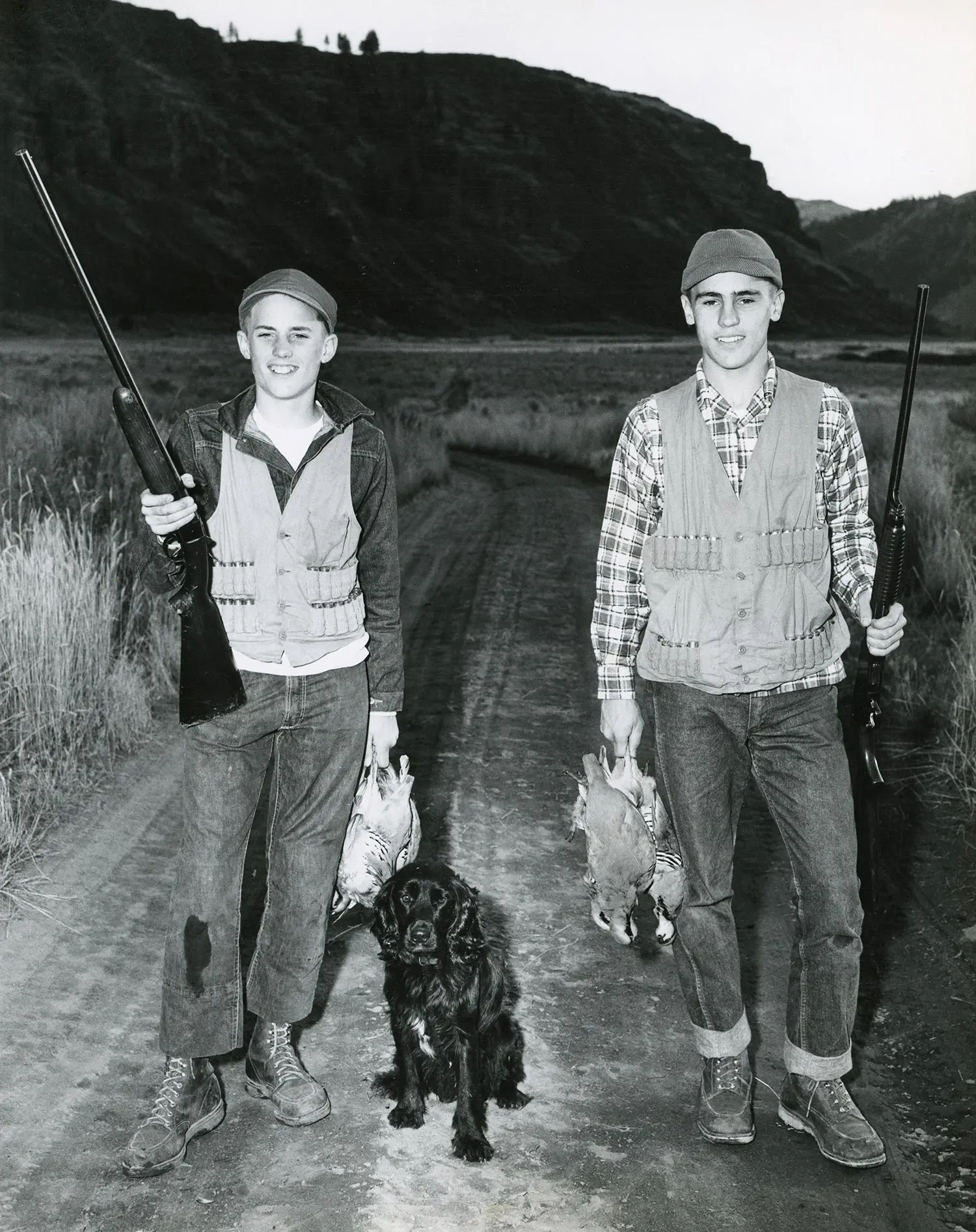 Two chukar hunters and their dog