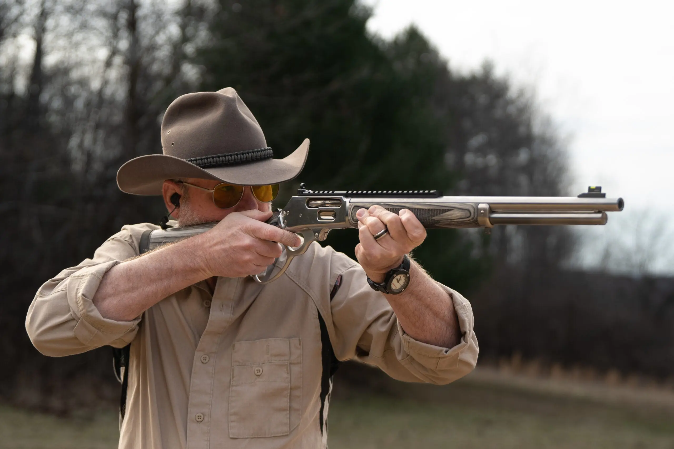 the author shooting a lever-action rifle