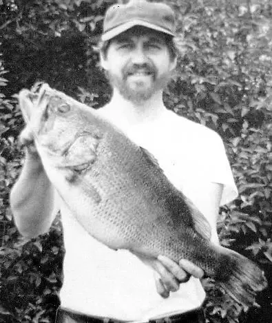 An angler poses with the New Jersey state record for largemouth bass. 