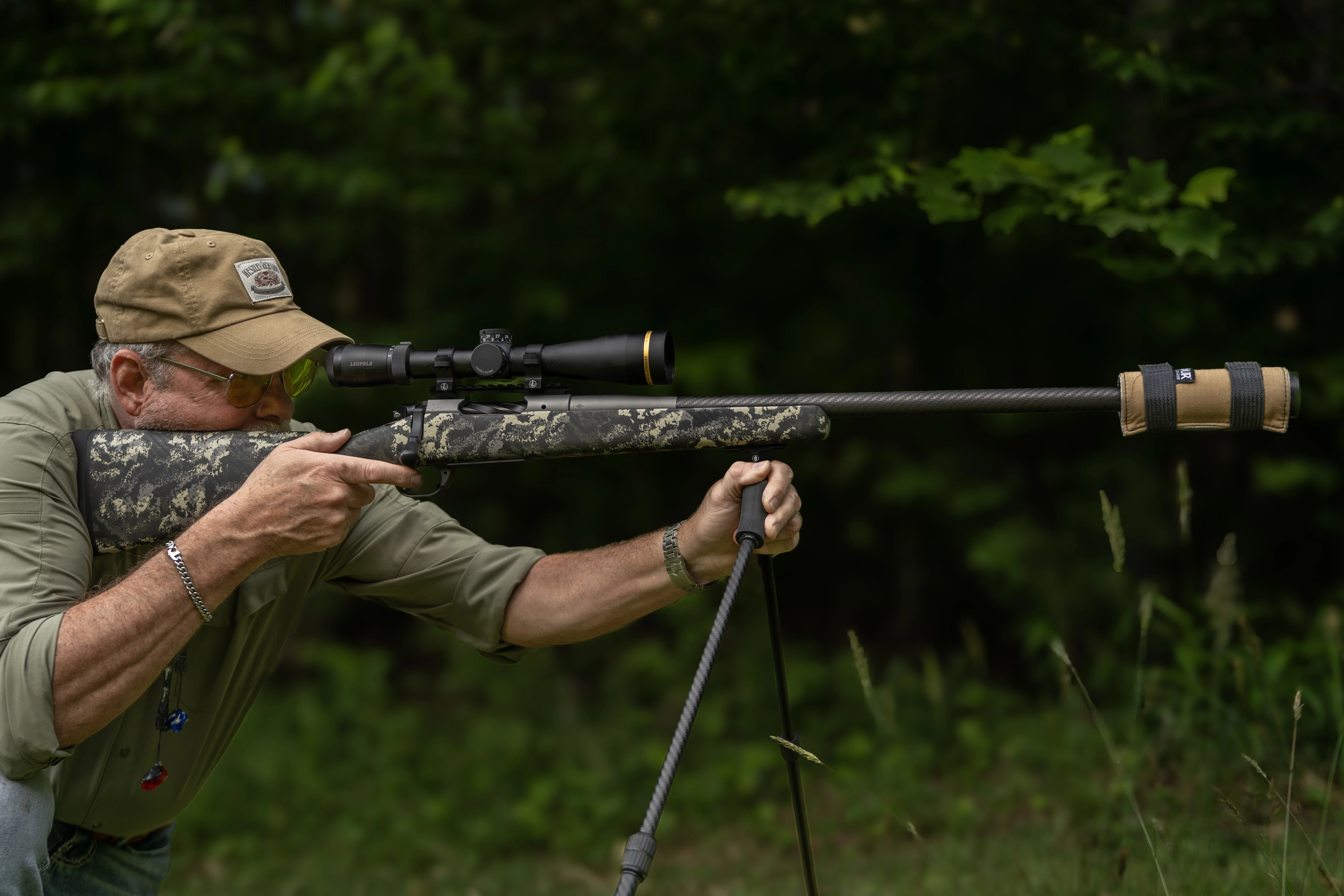 A shooter fires the Springfield Armory Model 2020 Boundary rifle with suppressor from shooting sticks. 