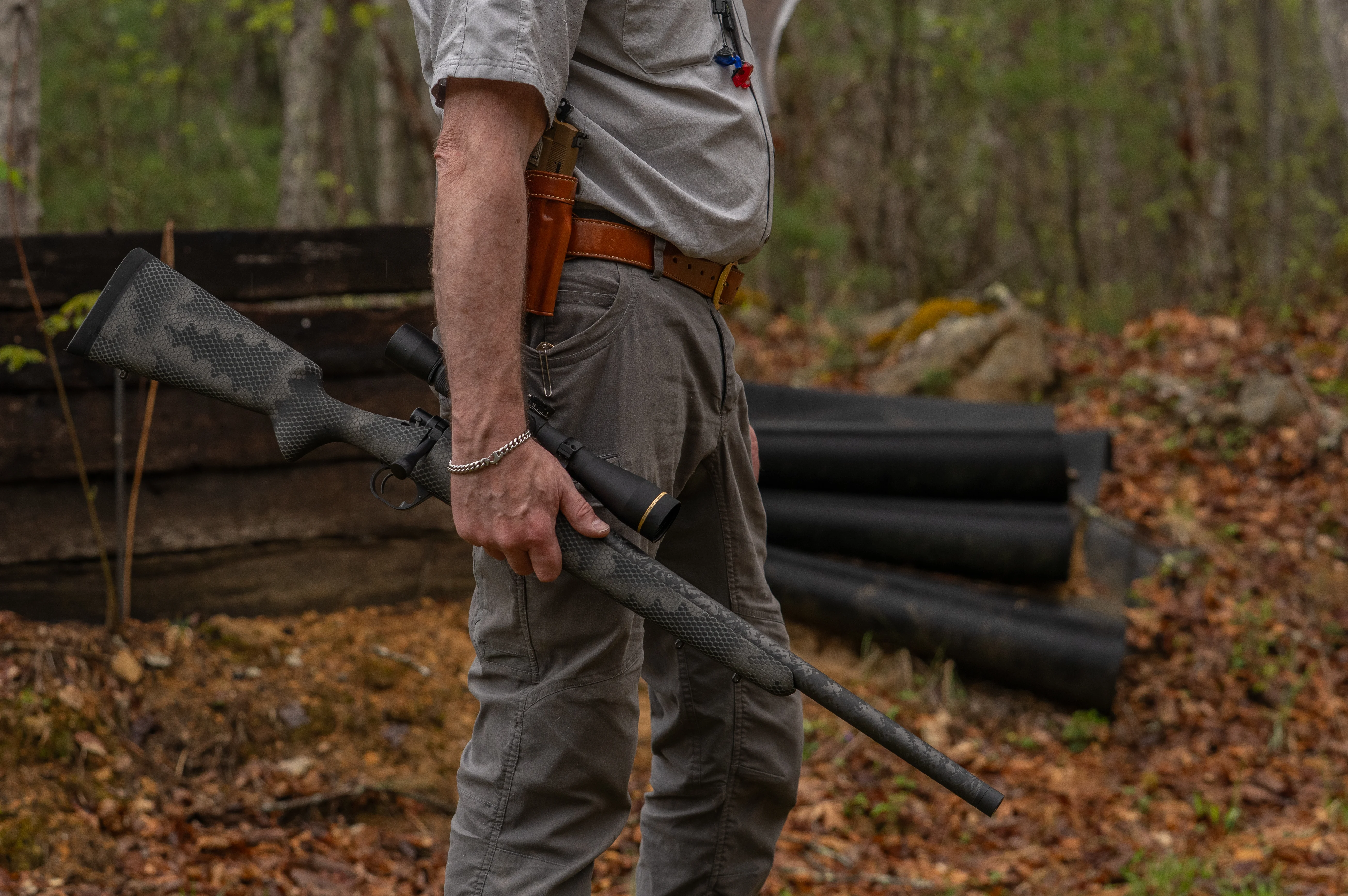A shooter holds the Proof Glacier Ti rifle by his side. 